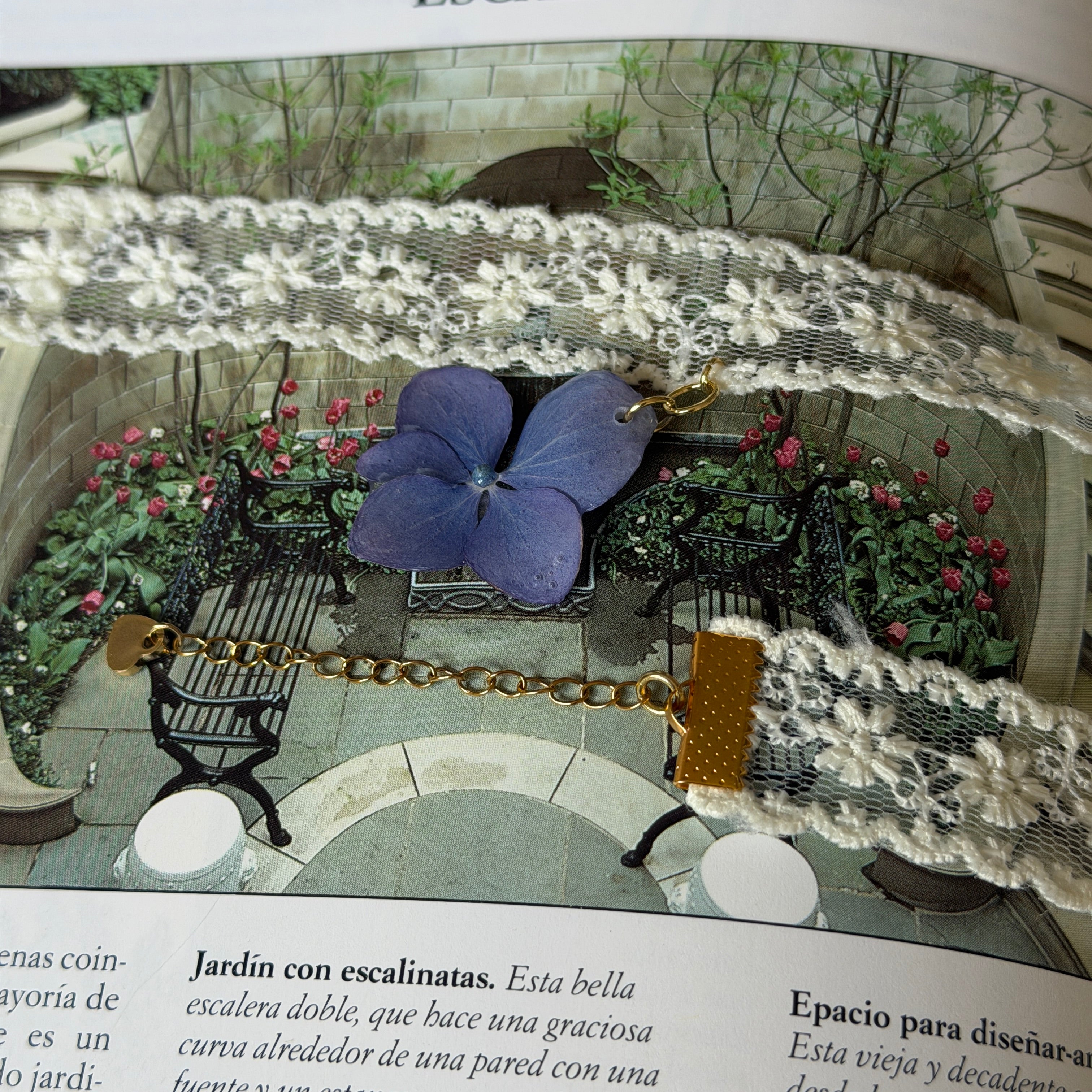 Gargantilla Soneto sobre libro: encaje crema con hortensia azul lavanda y cierre dorado de corazón